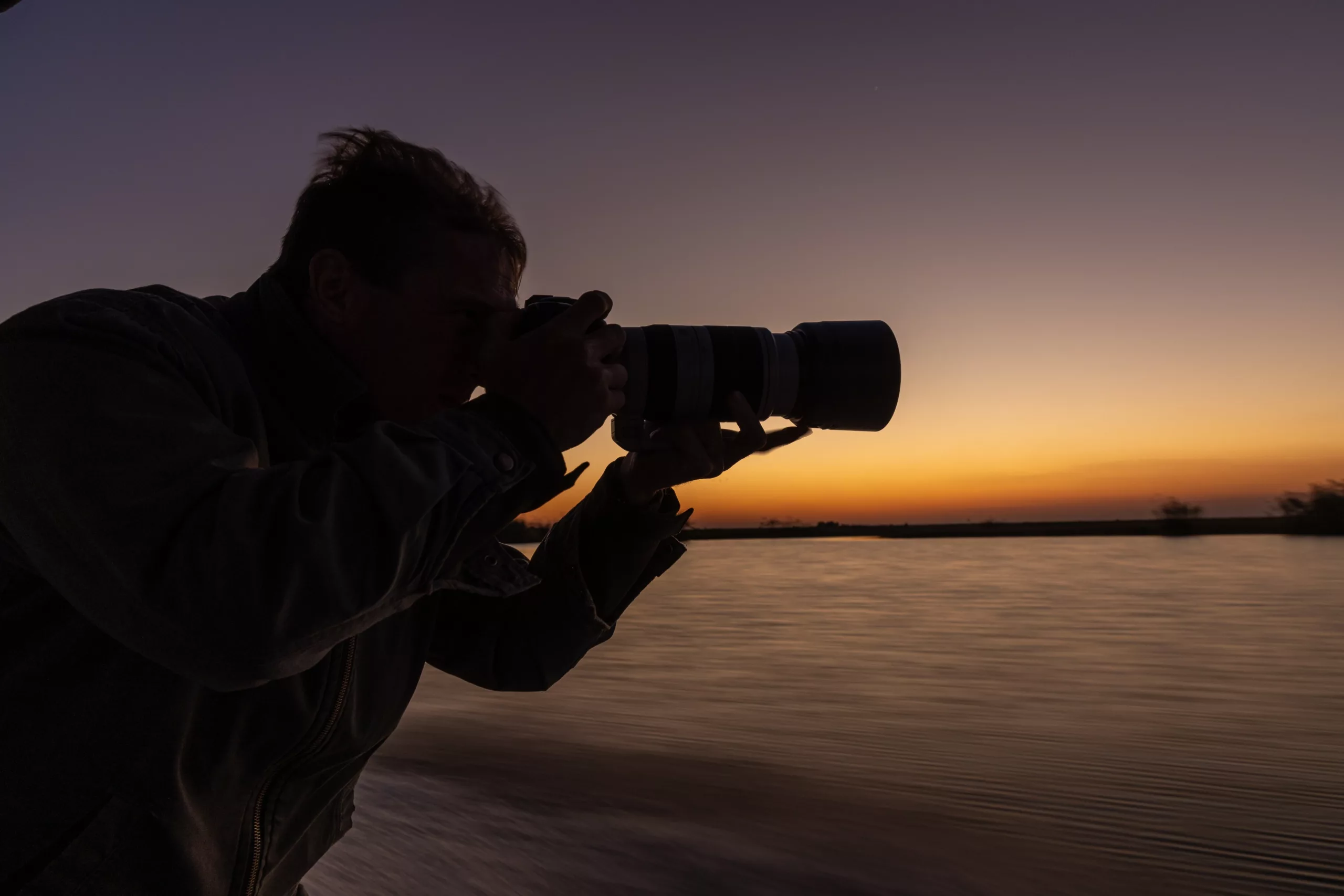 Guest-with-camera-gear-on-safari-in-Botswana-Pangolin-Photo-Safaris-scaled